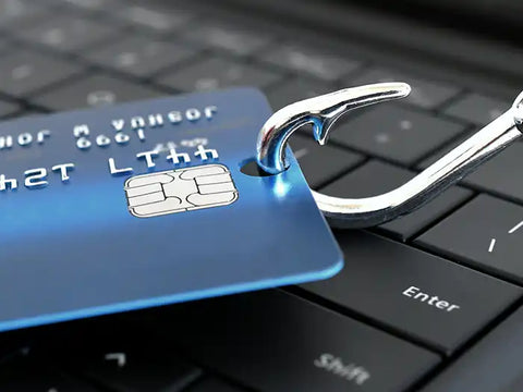Credit Card on a fishing hook on a computer keyboard. Concept for BEC online scams. 