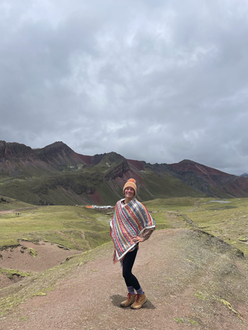 Ashley standing with Red Valley in the background at Rainbow Mountain in Peru