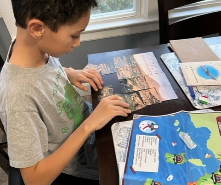 10 year old boy playing The Landmark Kids mystery geography box