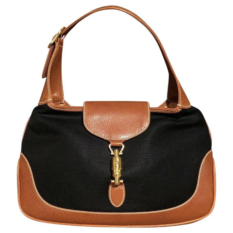 1961 Jackie hobo style shoulder bag, made in black linen canvas and camel leather with a gold piston closure and extender strap
