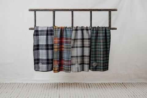 Pet blankets hanging from ladder in four colours