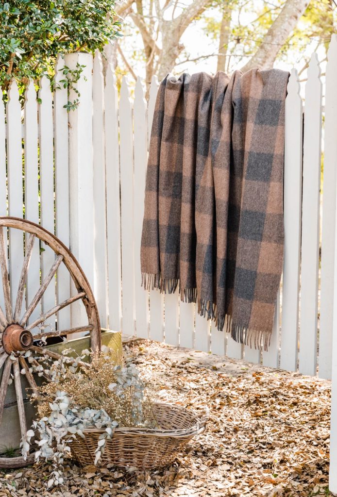 ash antipodean blanket hanging on fence