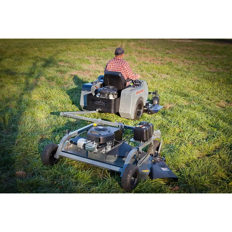 rear view of a man driving his lawn tractor with Swisher FC15560BS