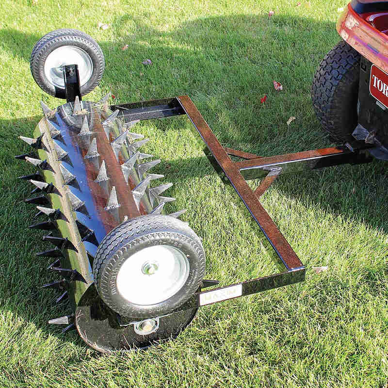 top view of maxim 36" tow behind spike aerator mounted on a lawn mower