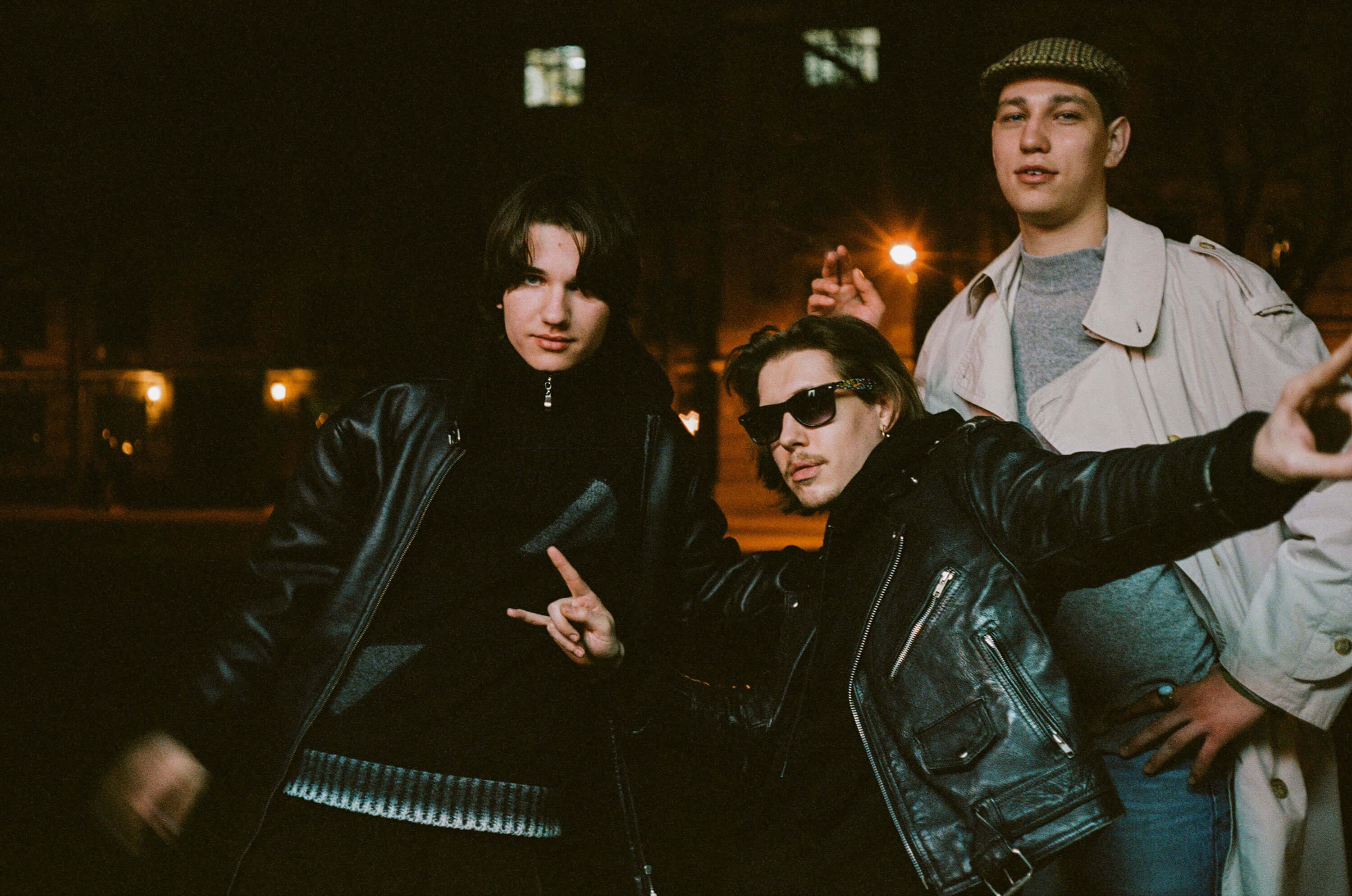 Three men outside wearing outerwear