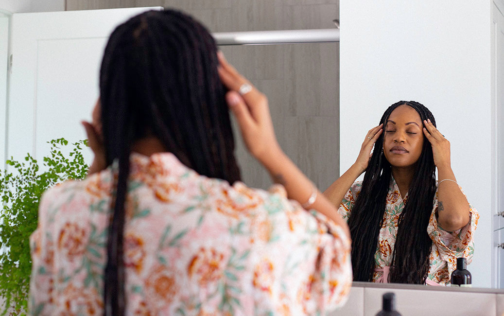 woman massaging healthy hair oil into scalp