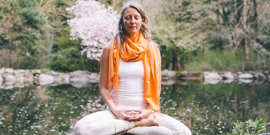 Banyan friend Janani meditates near a pond