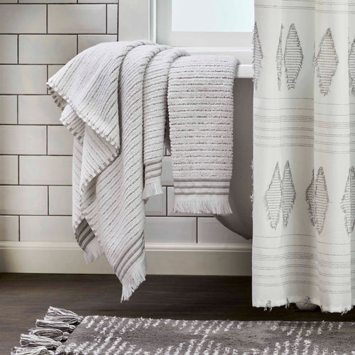 https://cdn.shopify.com/s/files/1/0672/0284/2838/products/Subtle-Stripe-White-Gray-Bath-Towel-lifestyle_46f140fc-2989-4609-9d19-3922111c529d_500x.jpg?v=1666629128