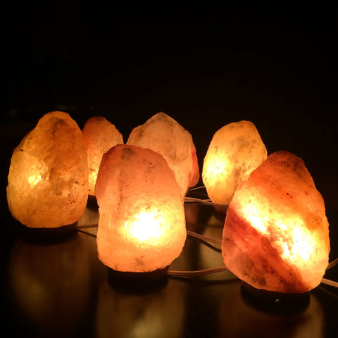 a group of lit himalayan salt lamps