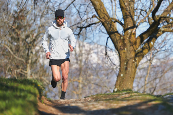 Picture of a runner with the Onpeak Performance Hat - The Ultimate Running hat. Stay cool and dry during intense workouts with this breathable and sweat-wicking gym hat. Designed for runners and fitness enthusiasts, this high-performance workout hat ensures comfort and style. Lightweight and ventilated, it's your go-to running accessory for a successful training session.