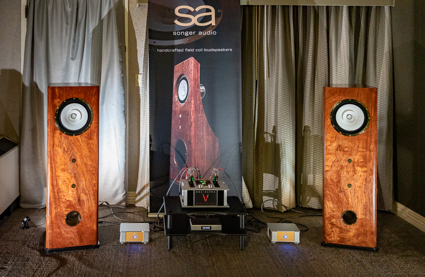 Songer Audio’s room featured their beautiful natural wood two-way, open-baffle, dipole, S2 speakers and a surprisingly clean and simple electronics chain. They utilized an affordable Topping D90SE DAC, and another Oregon-created product from Wilsonville, the Whammerdyne Heavy Industries 2A3 SET DGA Ultra amplifier brought those speakers to life. What does DGA stand for? Damn Good Amp!