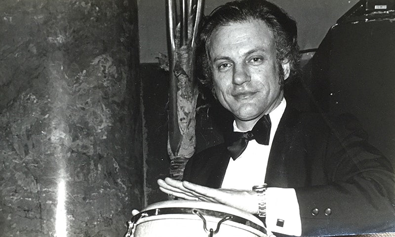Wasserman playing the conga drum at Herb Caen's birthday bash. Courtesy of Lani Mein.