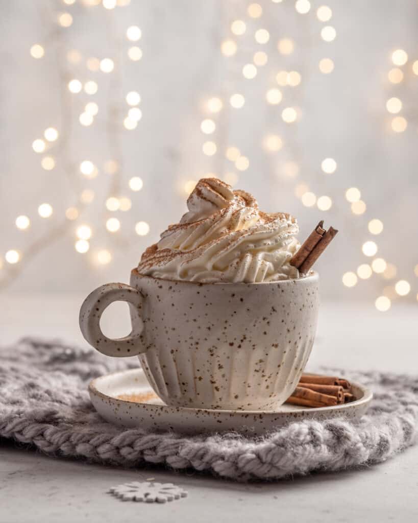 Gingerbread Latte  with cream and cinnamon stick in a ceramic cup. 
