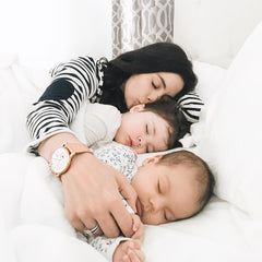 mum sleeping together with her two babies in organic baby clothes