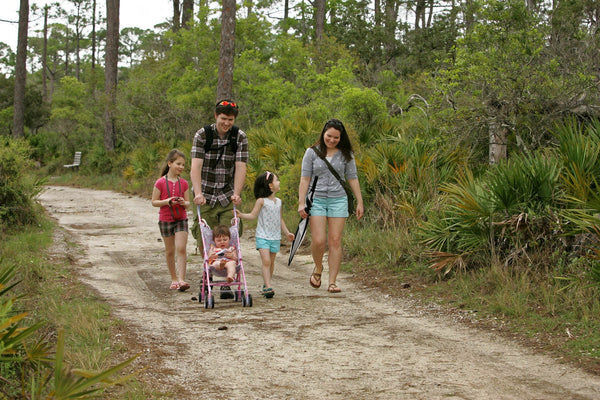 family walking in the woods