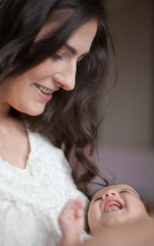 mother and baby smiling