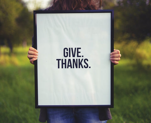 give thanks poster with person holding it