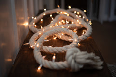 lighted rope garland laying on floor