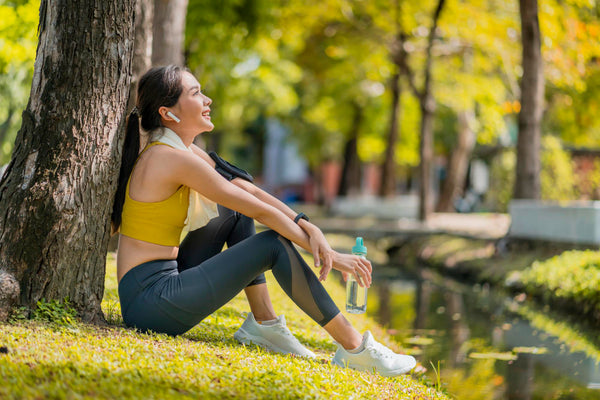 Image of woman taking a break to rest after run in the park