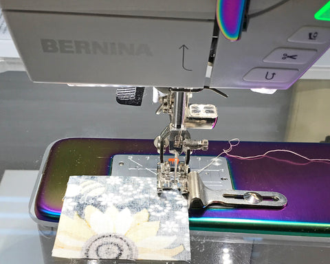 Bernina 770 with stitch guide screwed into the bed of the machine.