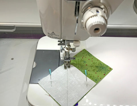 Sewing the corner squares on a flying geese unit