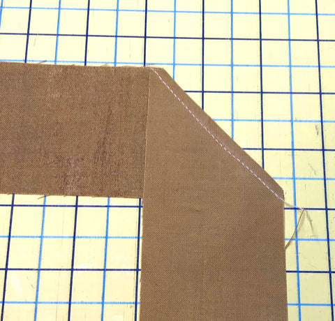 Quit binding sewn at a 90 degree angle and trimmed close to the stitching line.
