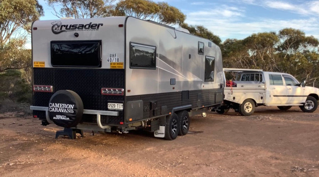 A caravan and 4 wheel drive parked up at the campsite in the outback of Western Australia.