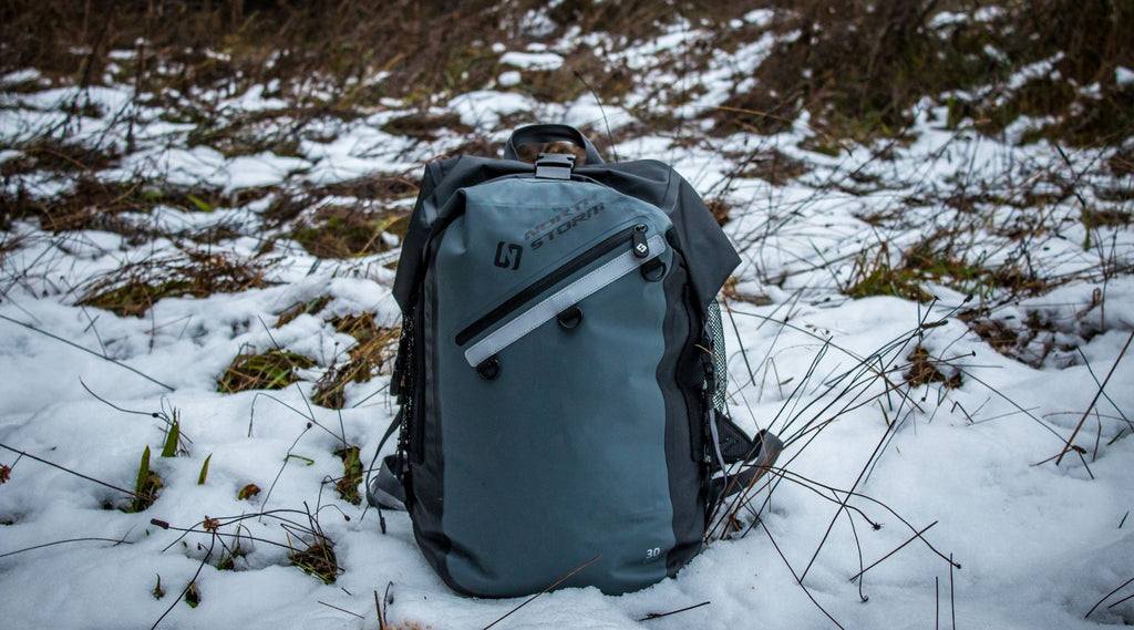 North Storm® Waterproof Backpack sitting in the snow. 