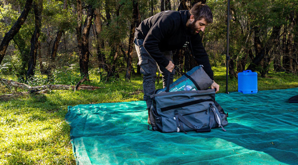 DAN OF EXPLORE DOWN UNDER PACKING A TENT INTO HIS NORTH STORM 60 LITRE DUFFEL BAG