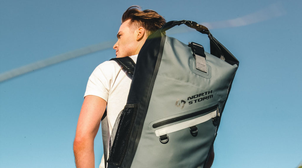 MAN WEARING A NORTH STORM WATERPROOF 30 LITRE BACKPACK.