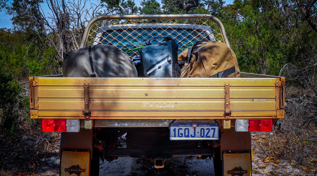 A UTE WITH A NORTH STORM 30 LITRE WATERPROOF BAG IN THE BACK.