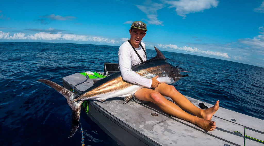 TIMMY TURTLE ON HIS SKIFF HOLDING A MARLIN