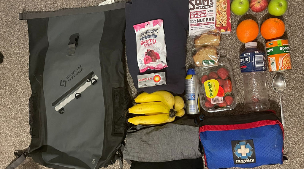 North Storm waterproof 30 Litre Backpack with food laid out next to it.