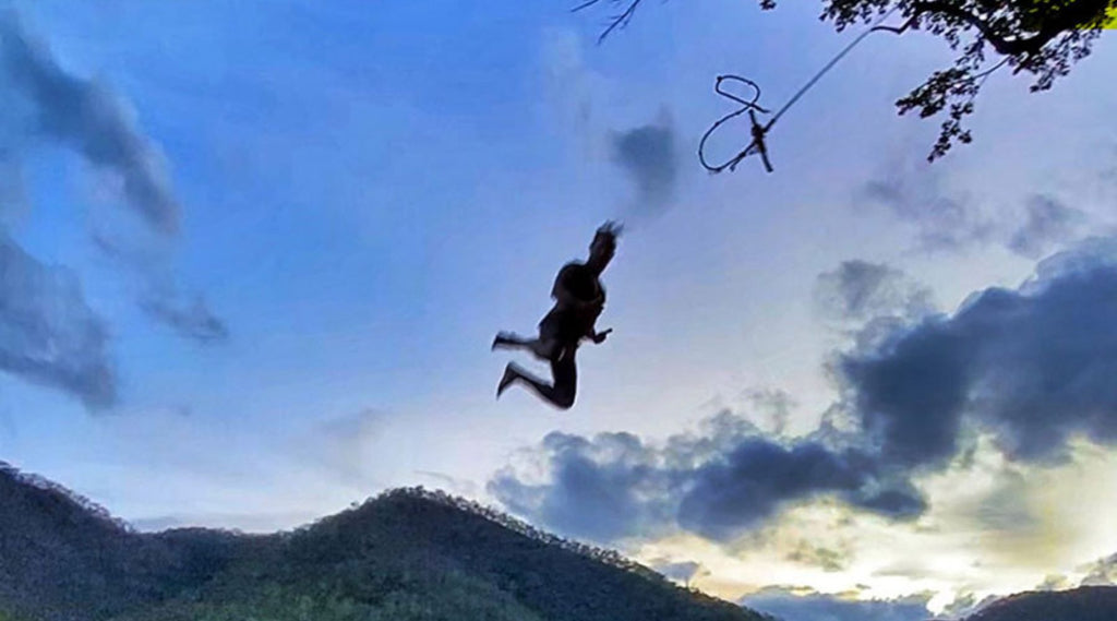 CHRIS OF AUSSIE DESTINATIONS UNKNOWN MID AIR AFTER JUMPING FROM A TREE SWING.