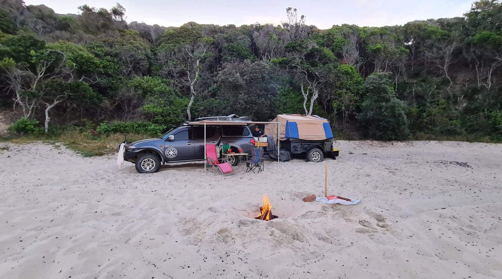 A car and camping set up on A four wheel drive with some wheel lift on the track down to McBrides Beach. 