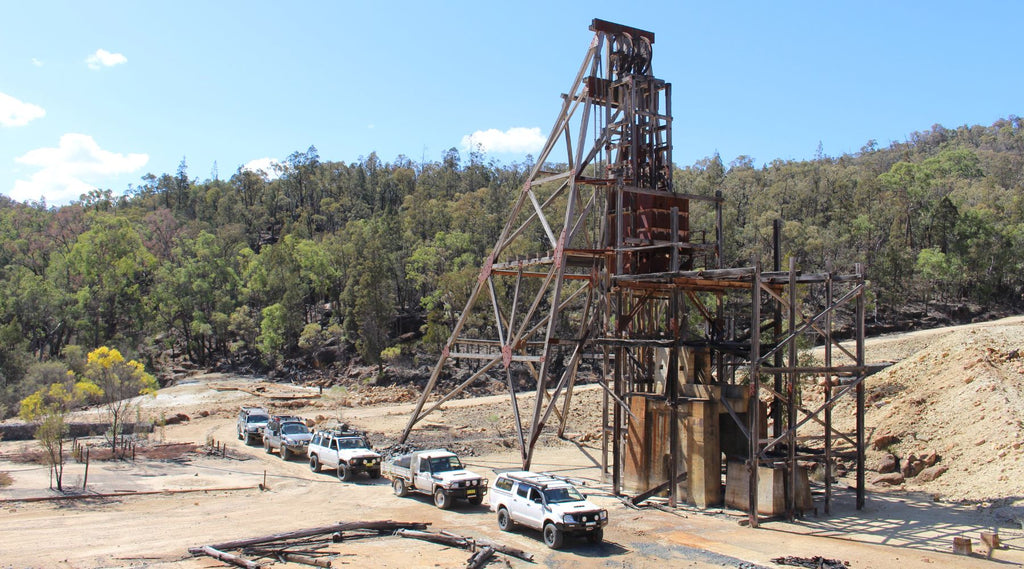 A LINE UP OF FOUR WHEEL DRIVES AT THE DRY DUSTY CONRAD SHAFT MINES.