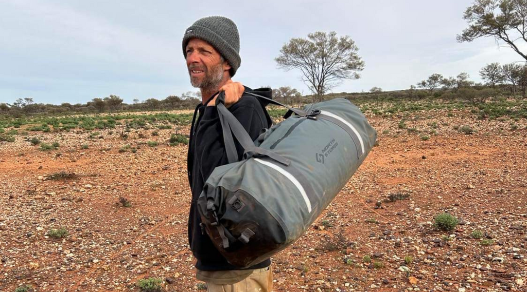 Waterproof and dust proof bag held by owner of North Storm in Western Australia outback