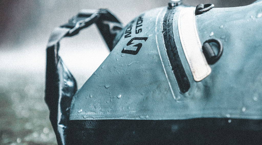 A North Storm waterproof backpack sitting in the rain.