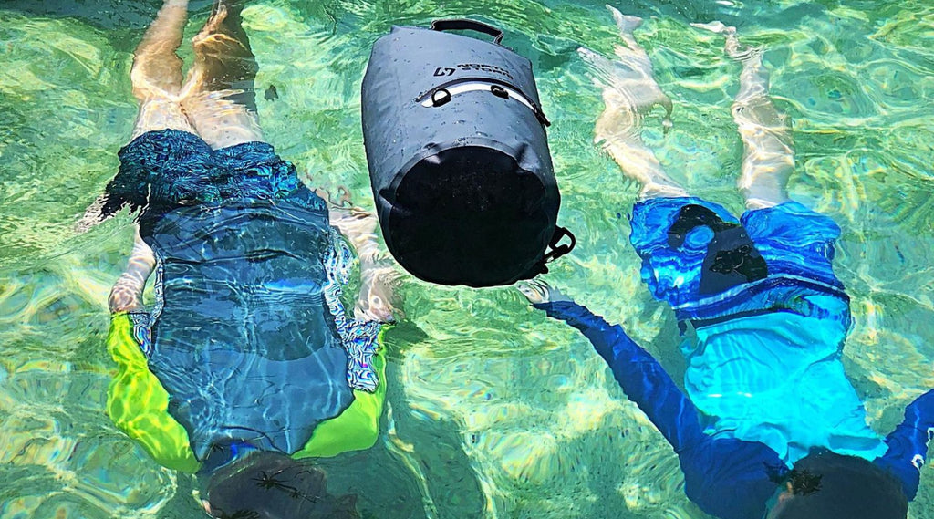 North Storm 20 Litre Dry Bag in a pool with children swimming underwater.