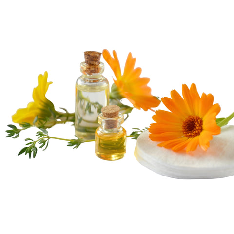 2 glass bottles of calendula oil surrounded by 3 yellow calendula flowers and some leaves