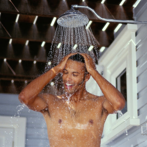 Man showering outside beside house