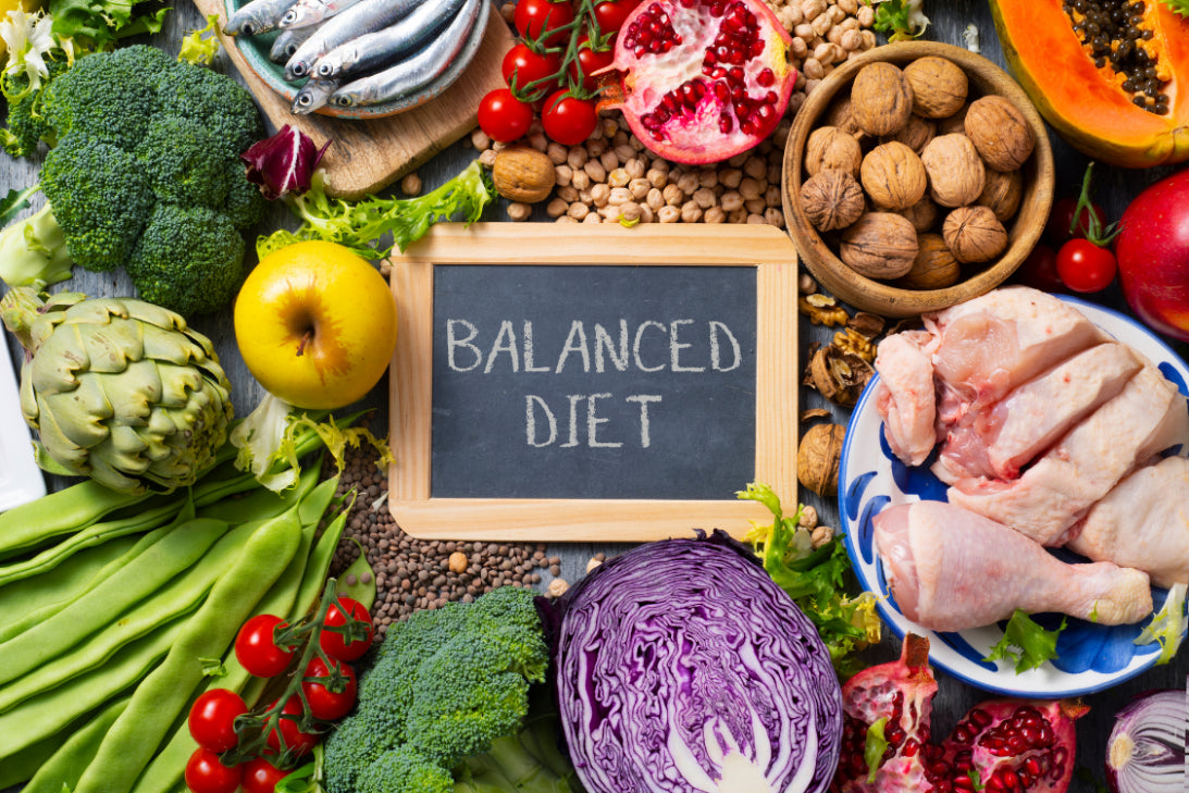 Assorted healthy foods for a balanced diet including fruits, vegetables, fish, and nuts to help prevent gout and manage uric acid levels.