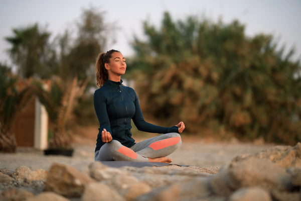 Woman meditating with nature. Image by Freepik