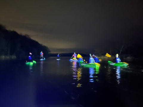 kayaks and paddleboards by headlight on water with Och Aye Canoe