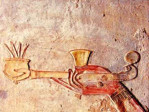 Photo of a burning Egyptian incense burner on a hand