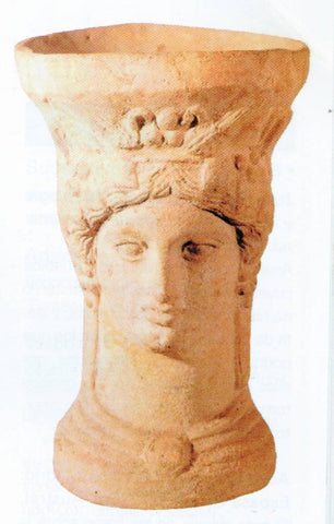 Greek style stone censer in the shape of a head representing a Greek god.