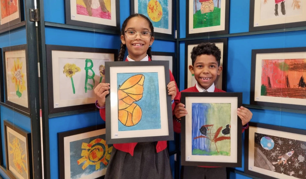 Children from St Modwen holding their artwork