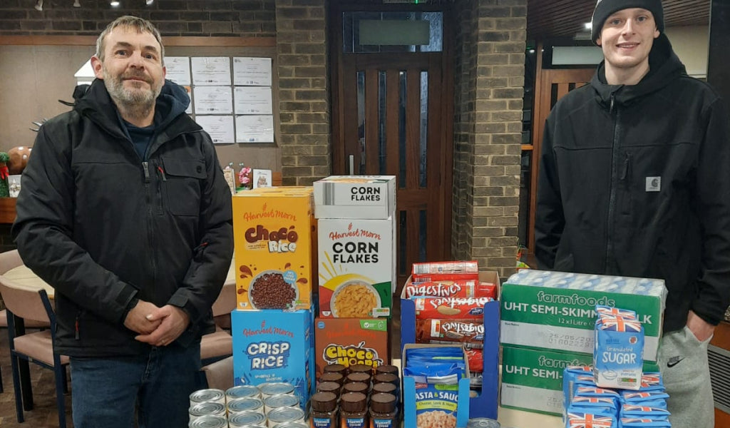 Images team members making donation to local food bank