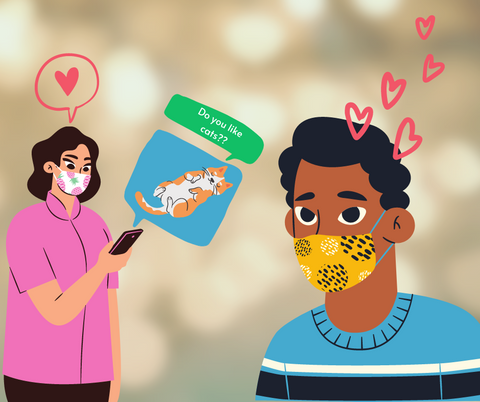 A cartoon of two people wearing masks. One texts the other to ask them if they like cats.