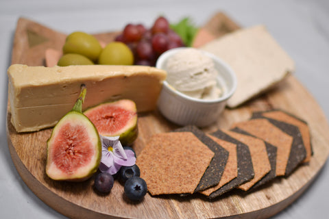 A tasting board of vegan cheese and fruit